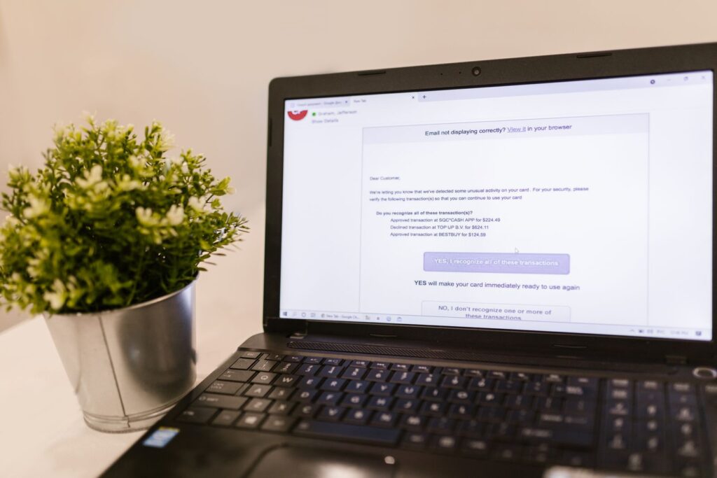 A laptop open to an email inbox beside a houseplant, illustrating how to secure your email account